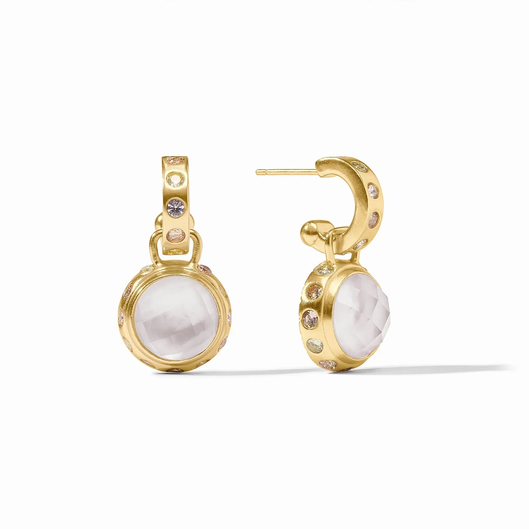 Gold earrings with white stone centers on a white background