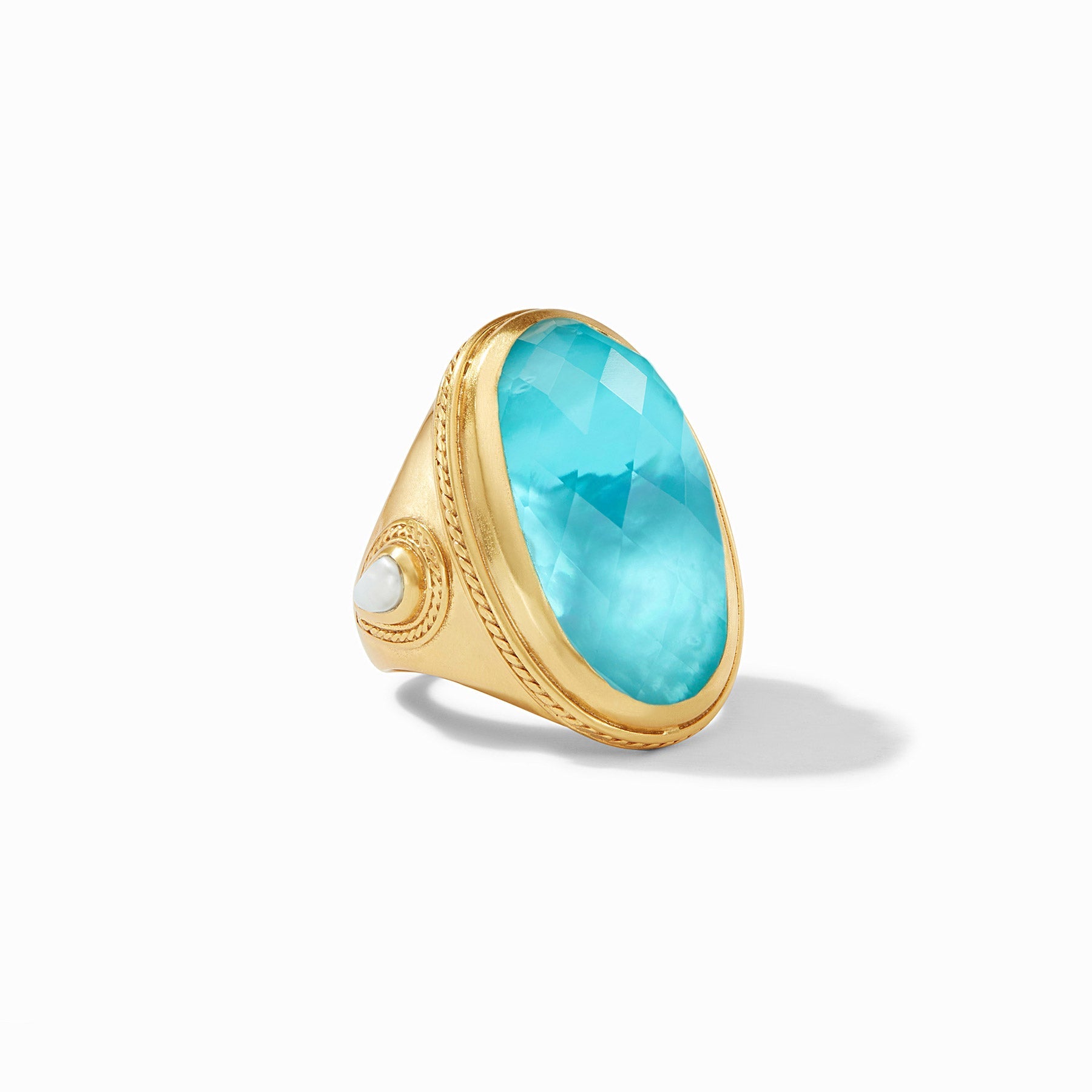 Gold ring with a large turquoise stone on a white background
