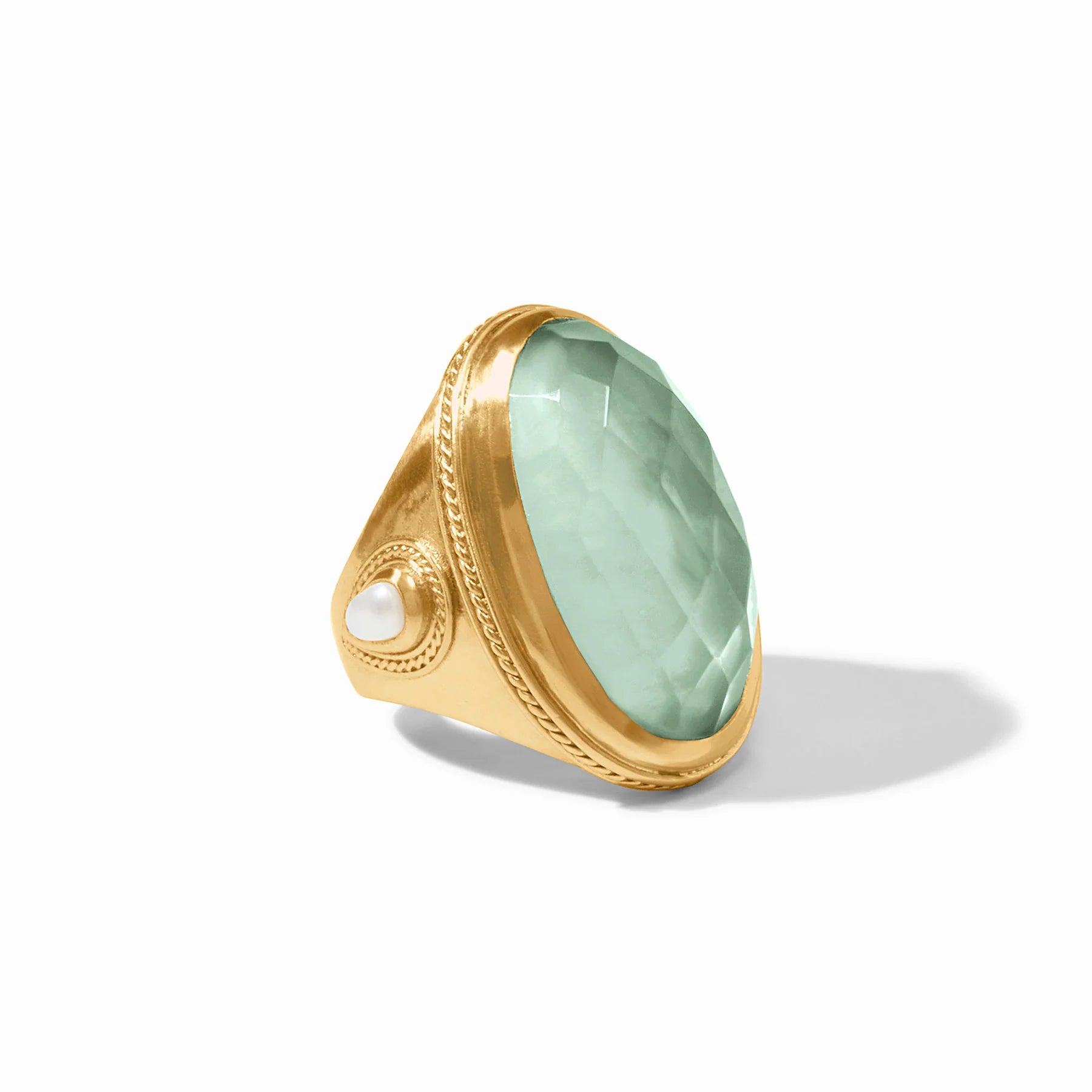 Gold ring with a green gemstone on a white background
