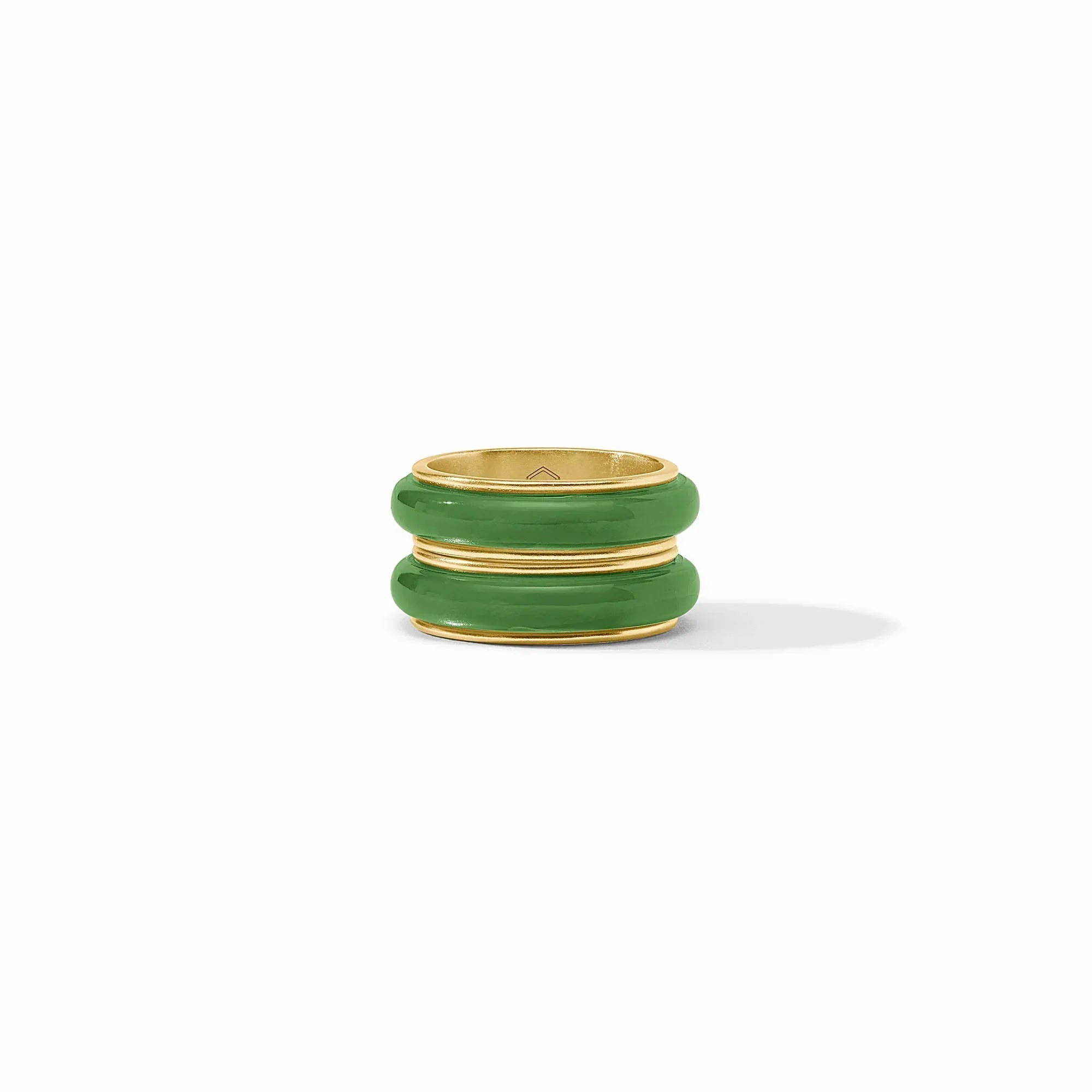 Set of green rings with gold bands on a white background