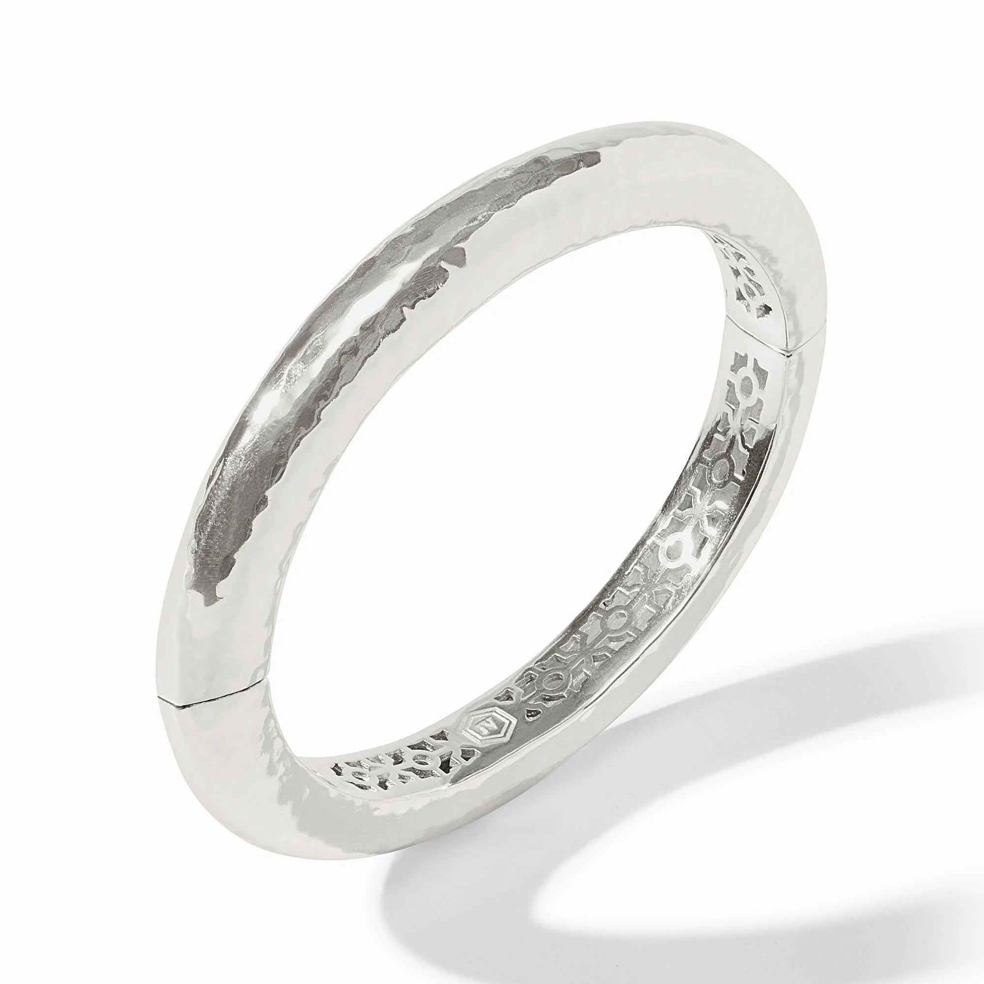 Silver ring with textured design on a white background