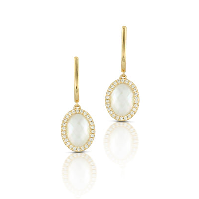 Gold earrings with white stones on a white background