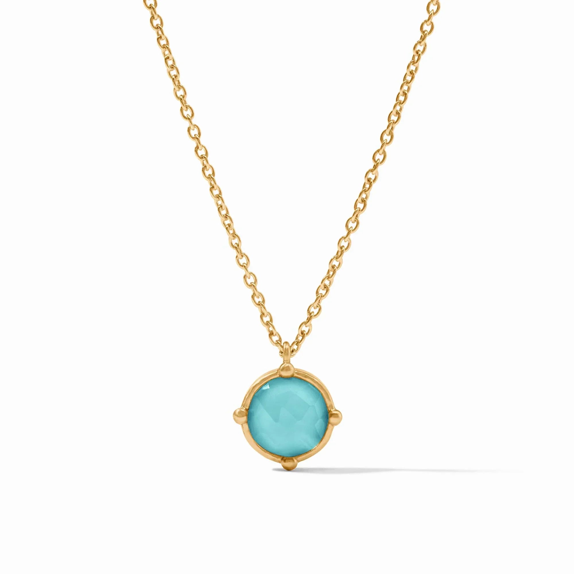 Gold necklace with a turquoise pendant on a white background