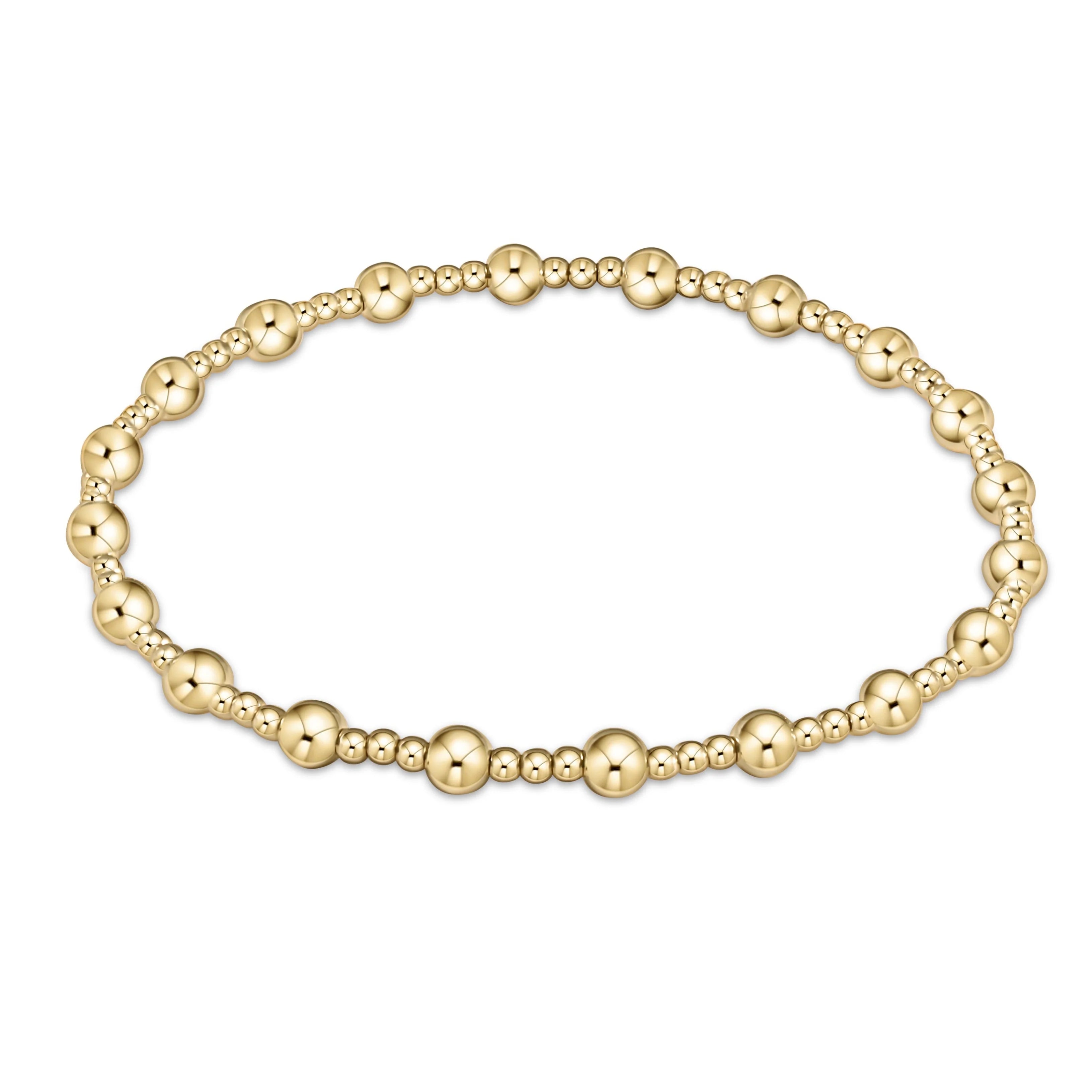 Gold beaded bracelet on a white background