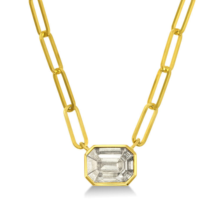 Gold chain necklace with a rectangular crystal pendant on a white background
