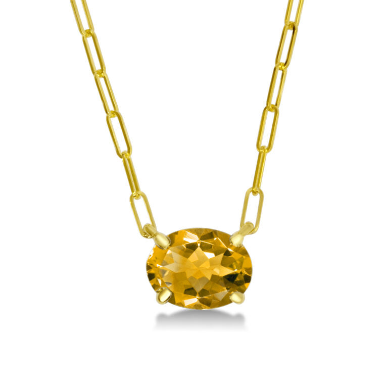 Gold necklace with a yellow gemstone on a white background