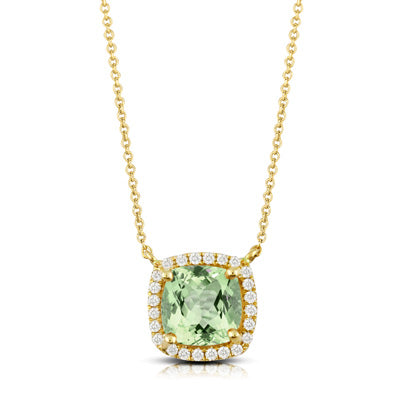 Gold necklace with a green gemstone pendant on a white background