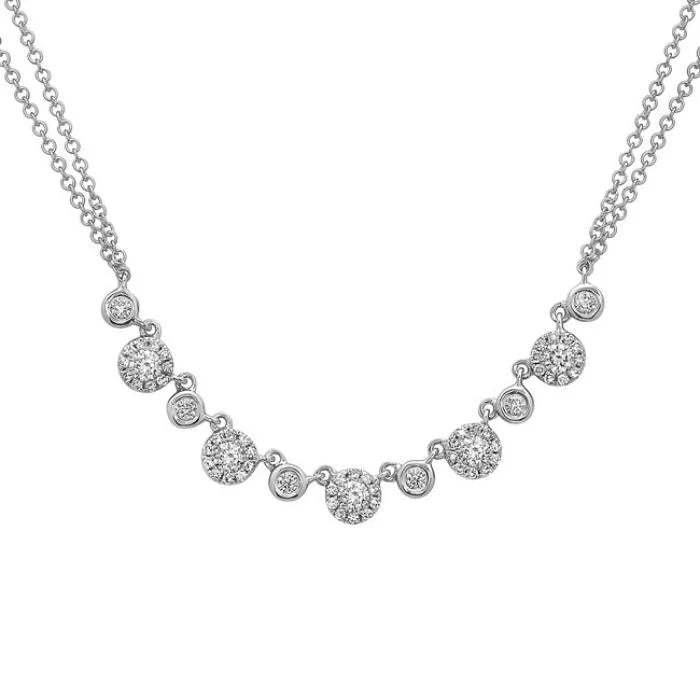 Silver necklace with circular pendants on a white background