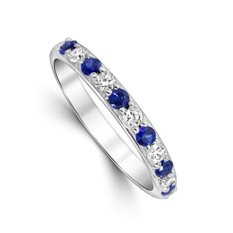 Silver ring with blue gemstones on a white background