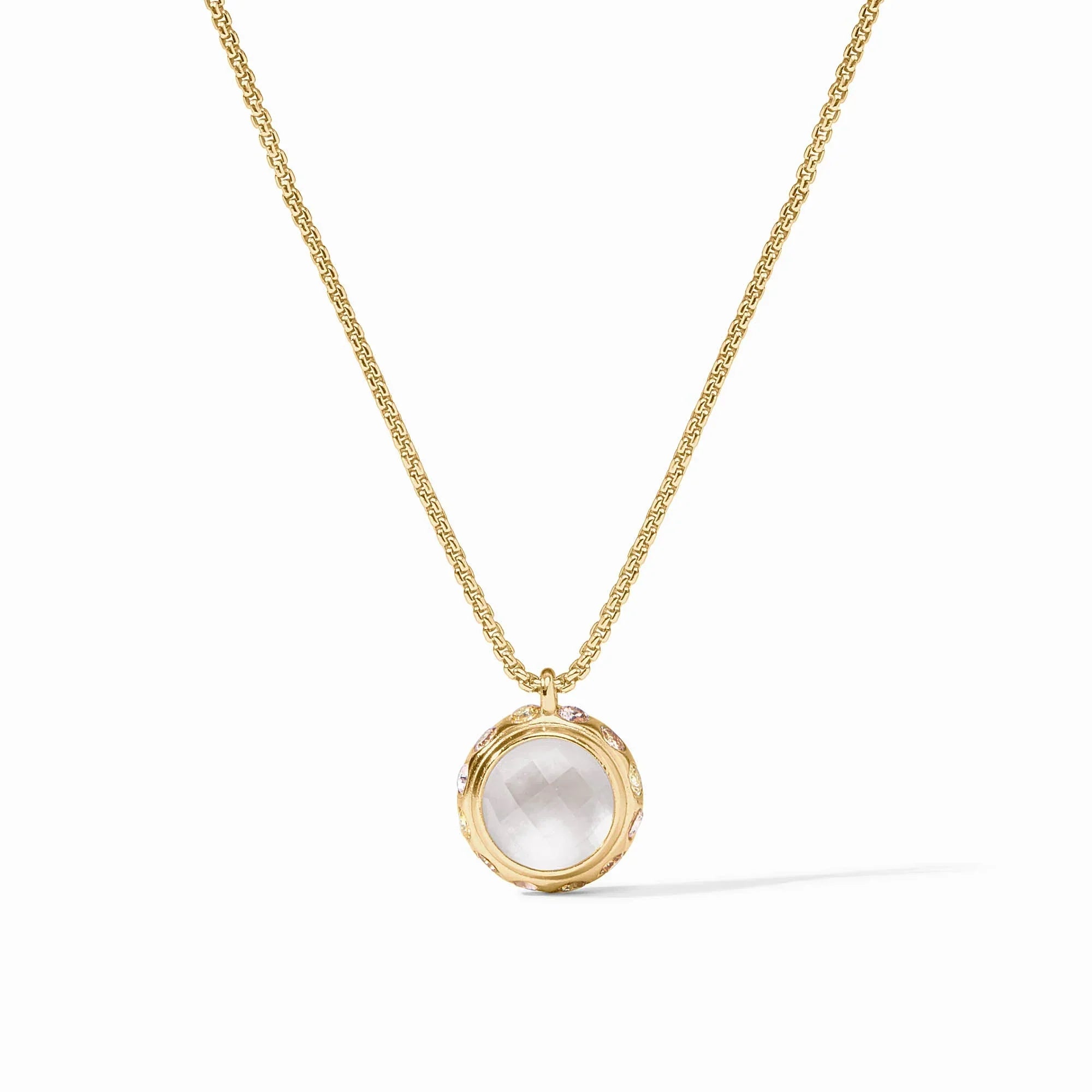 Gold necklace with a round pendant on a white background