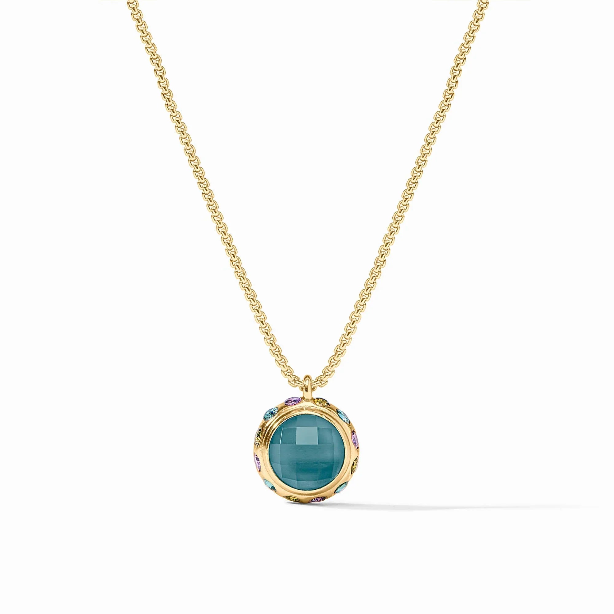 Gold necklace with a green pendant on a white background