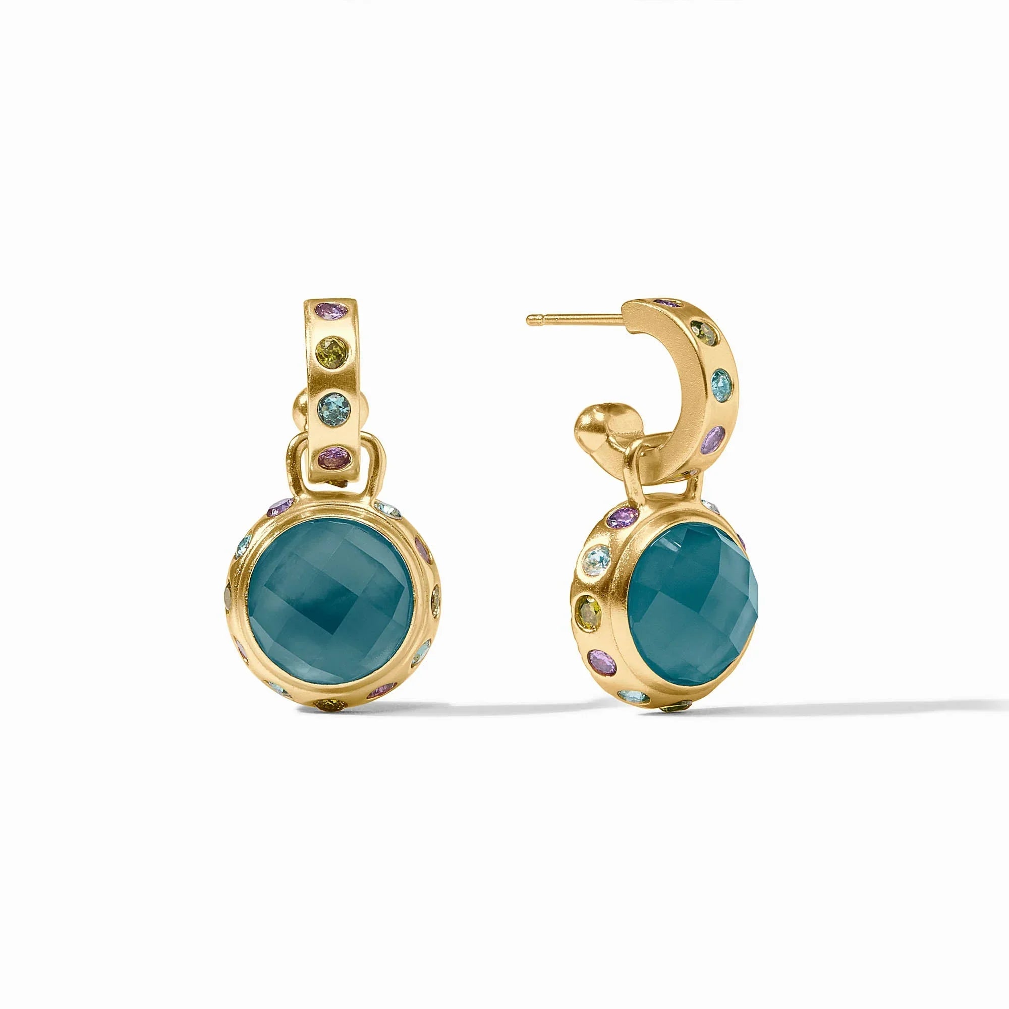 Gold earrings with teal stones on a white background