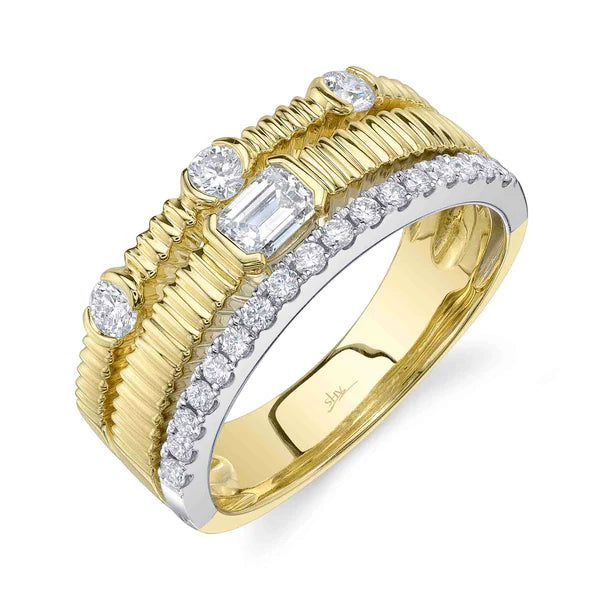 Gold ring with diamond accents on a white background