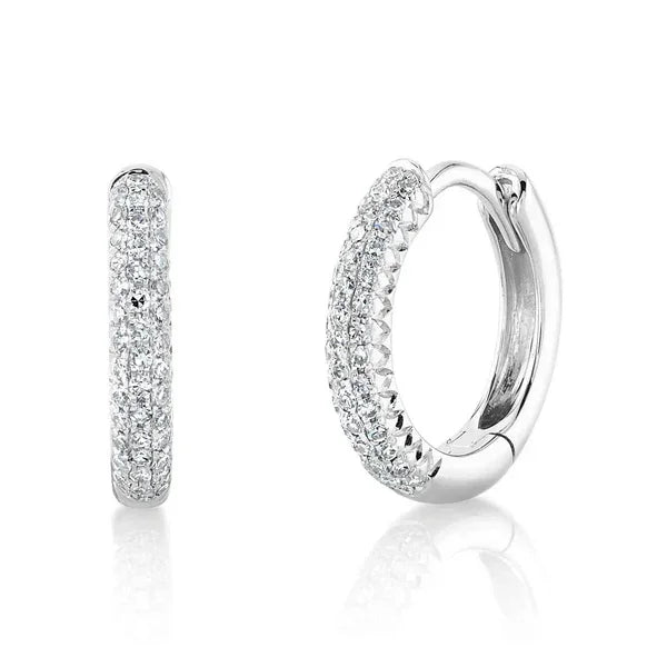 Pair of silver hoop earrings with clear gemstones on a white background