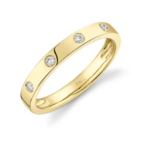 Gold ring with embedded diamonds on a white background