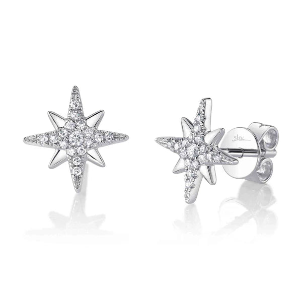 Star-shaped silver earrings with clear gemstones on a white background