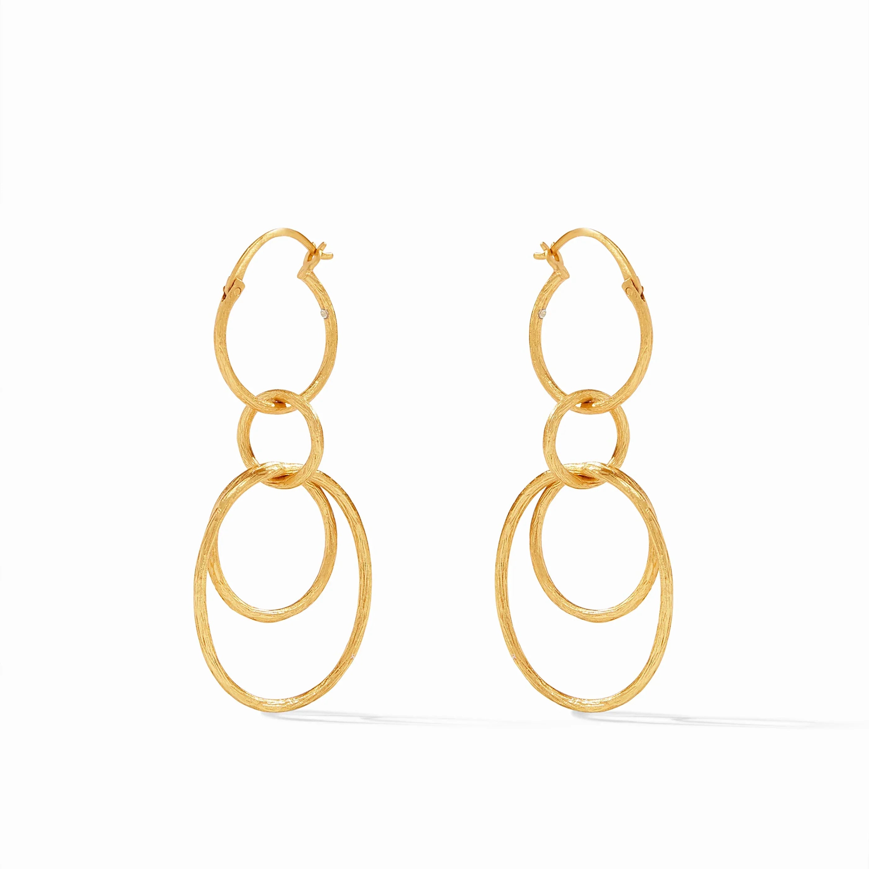 Gold hoop earrings with layered circular design on a white background