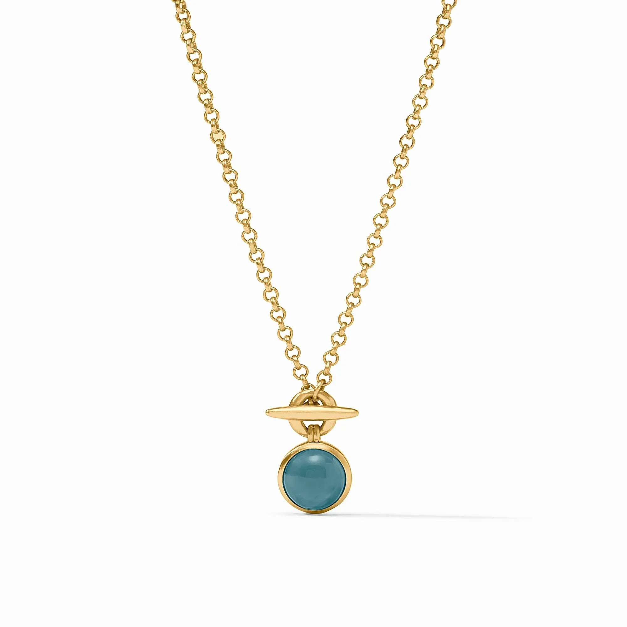 Gold necklace with a blue pendant on a white background