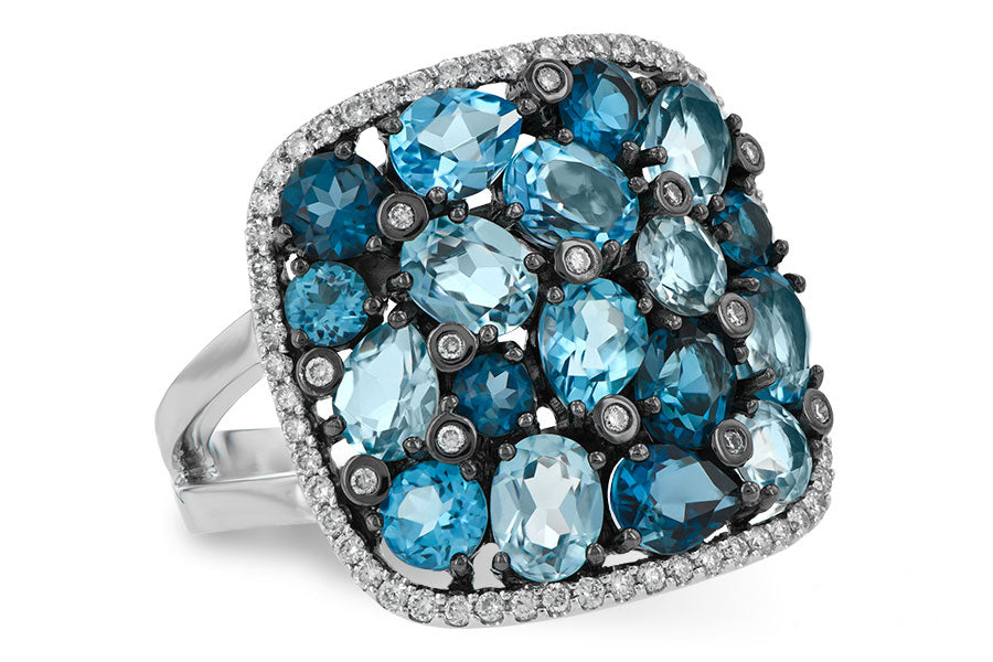 Ring with blue gemstones and silver accents on a white background